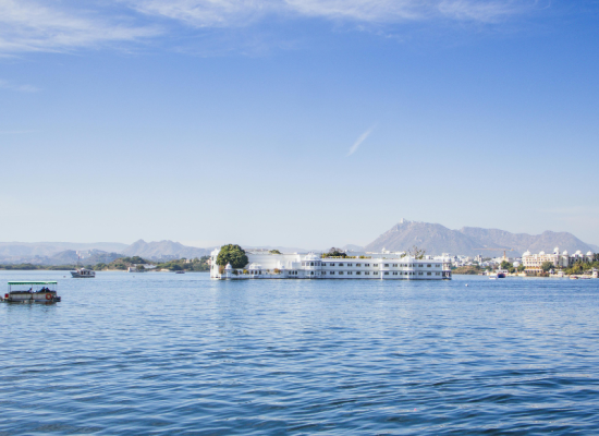 A traditional boat on Lake Pichola during a golden sunset in Udaipur